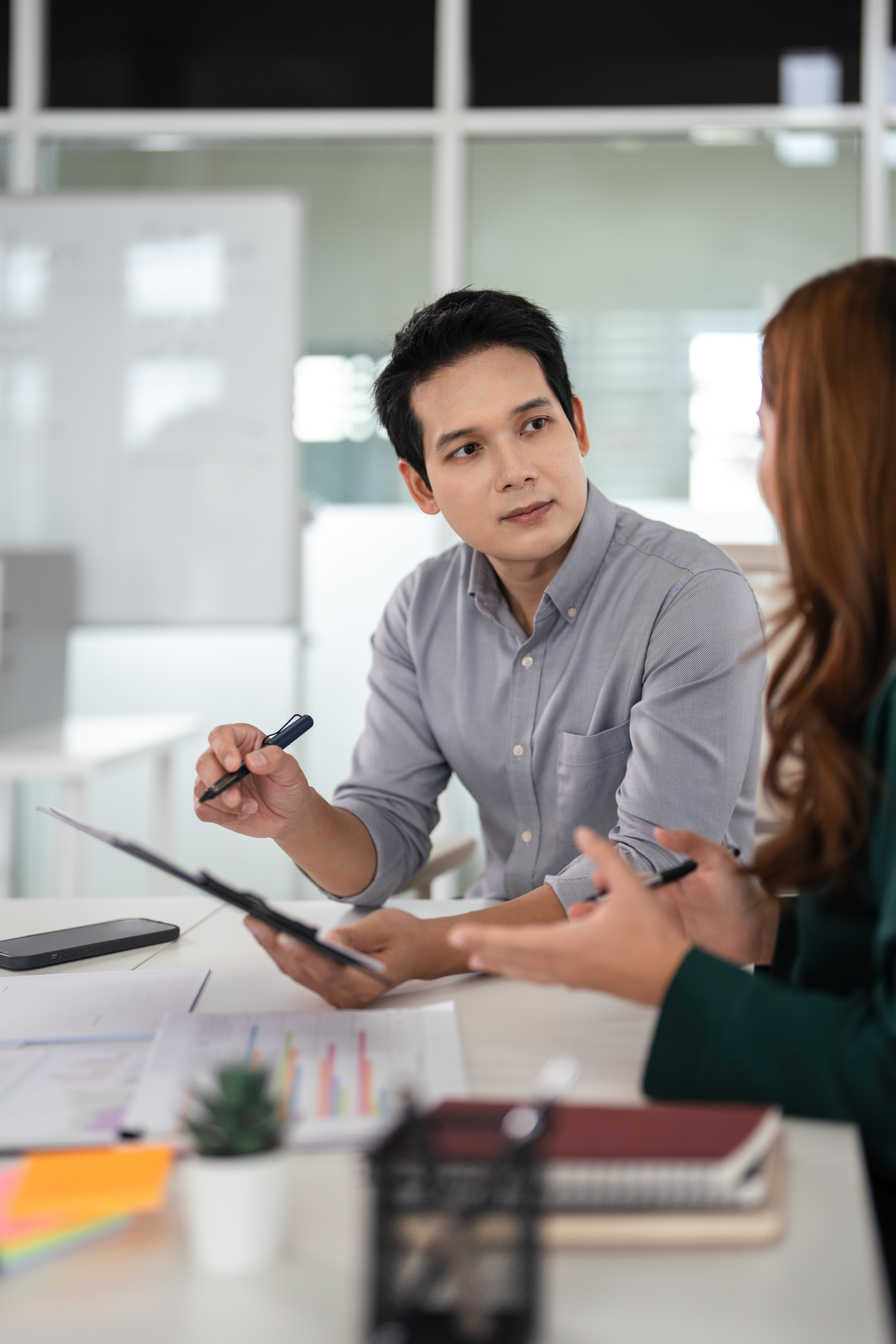 Asian Businesspeople working with papers for planning, financial analysis and chart.  discussion in boardroom for investment, risk management or budget report.